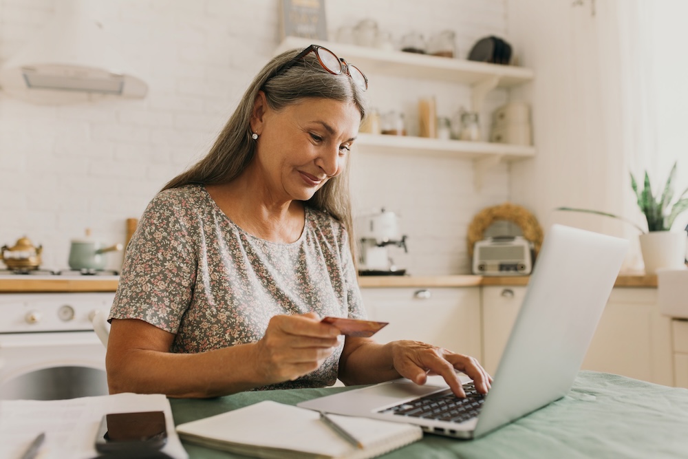 lady shopping on the computer with card