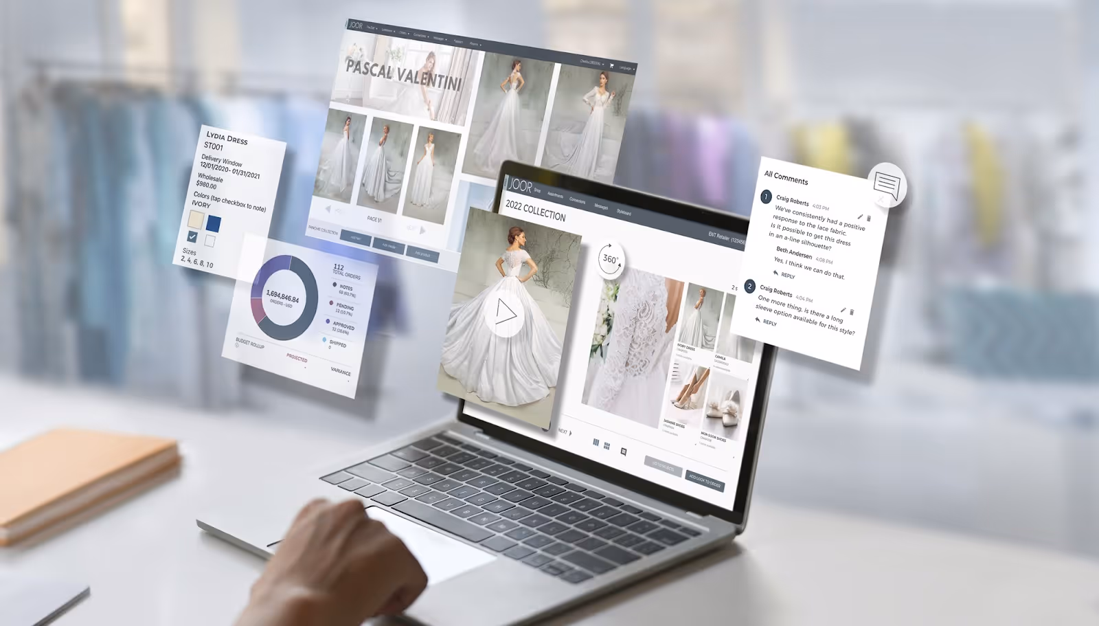 Laptop screen showing JOOR's wholesale management software, with pie chart analytics and images of white dresses