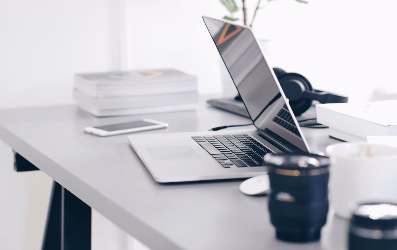 Modern workspace with laptop, smartphone, and accessories symbolizing digital tools and remote operations enabled by B2B wholesale marketplace platforms.