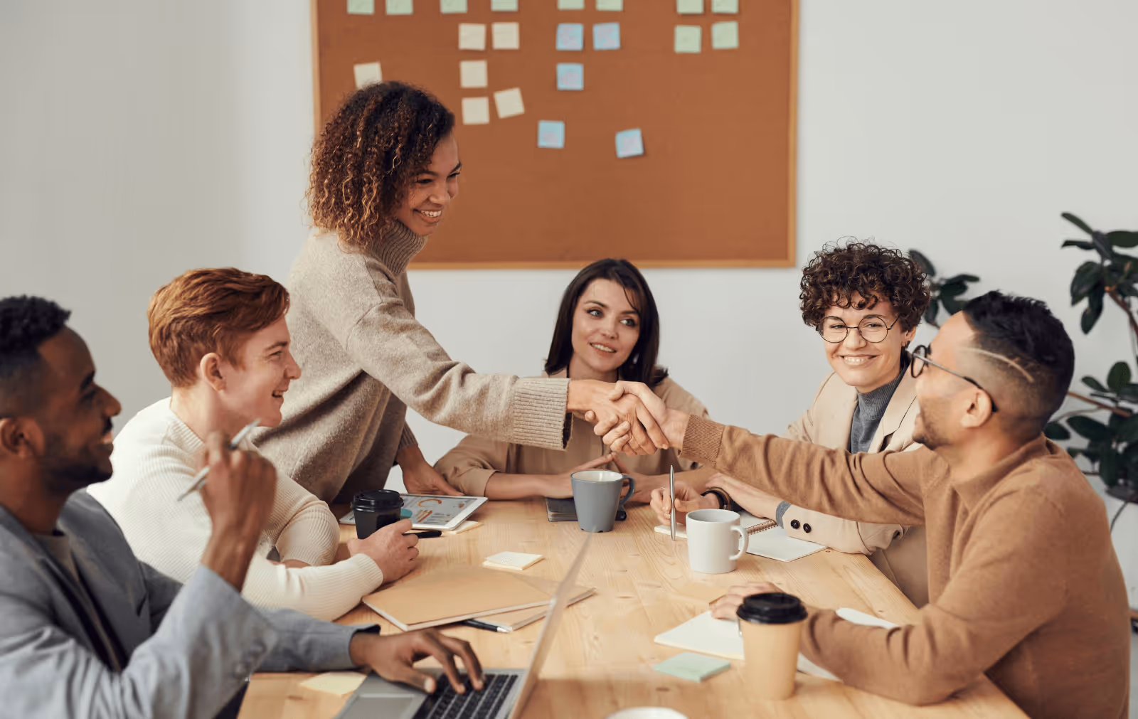fashion buyer shaking hands with brand ambassador at meeting after agreeing on a deal 