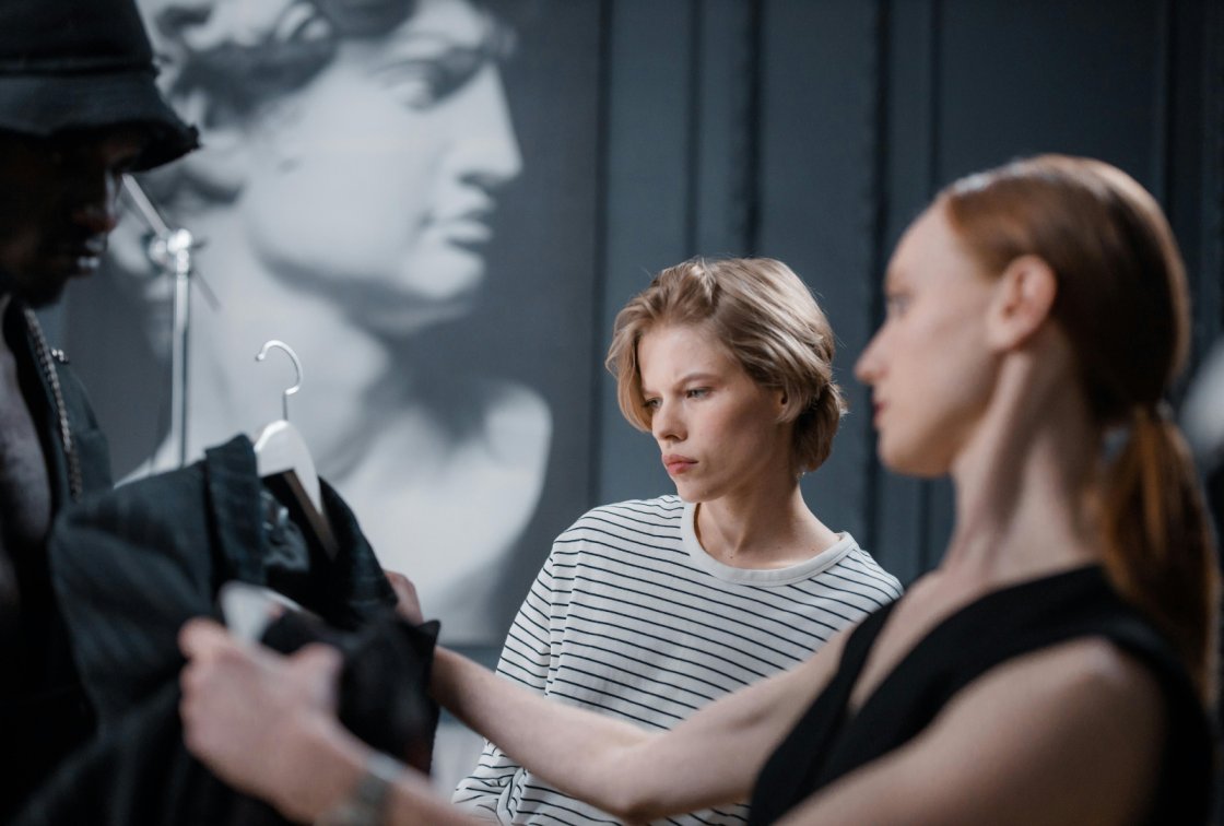 Two models analyzing a fashion piece.