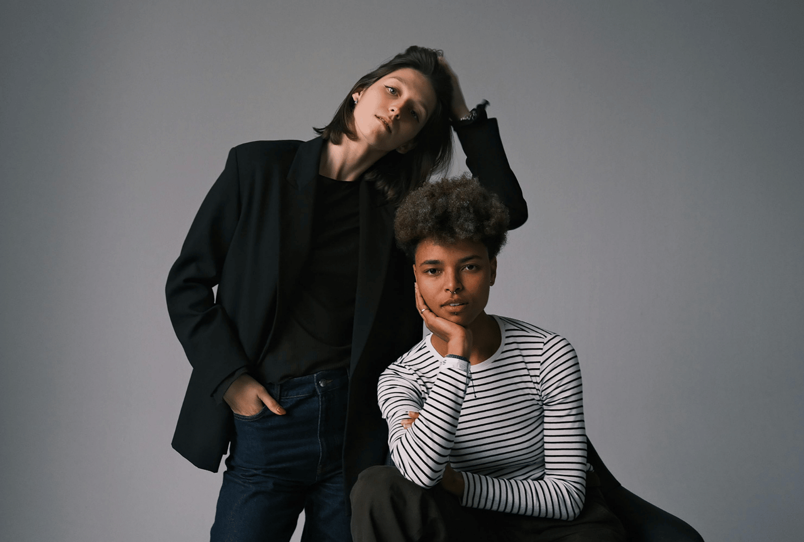 Two fashion models posing side by side.
