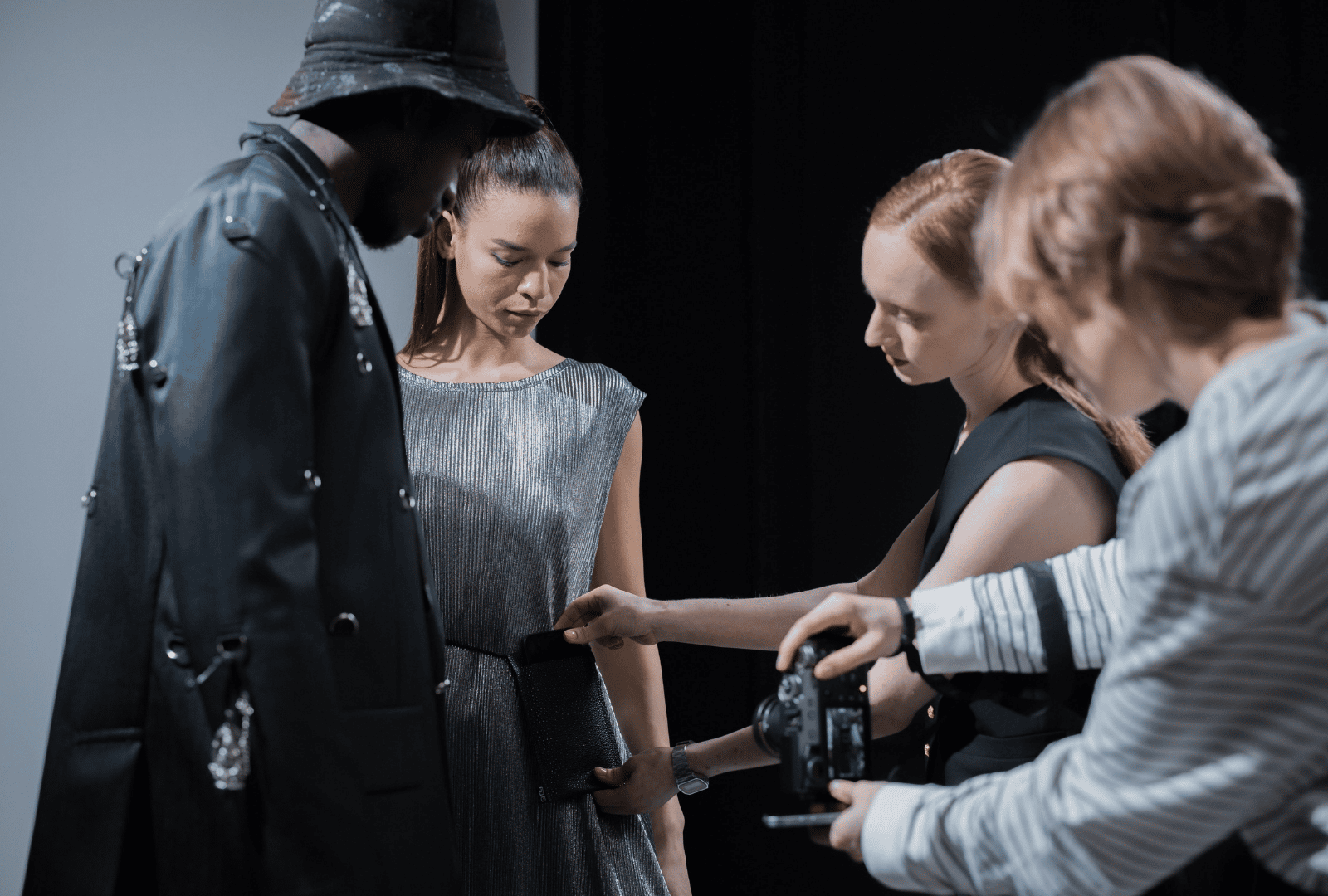 Two models in sharp clothes getting ready for a shoot
