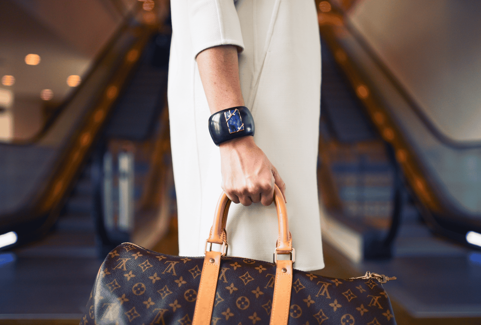 A fashionable woman holding a Louis Vitton bag