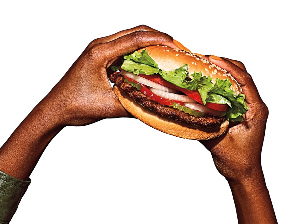 Hands holding whopper.