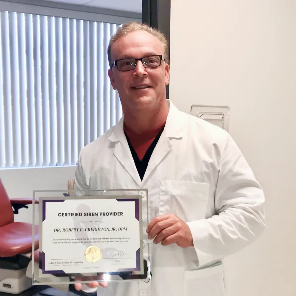 Dr. Creighton showing his certified Siren provider certificate.