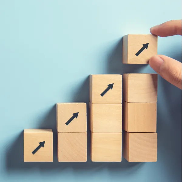 A stack of small wooden blocks that gets progressively taller moving to the right.