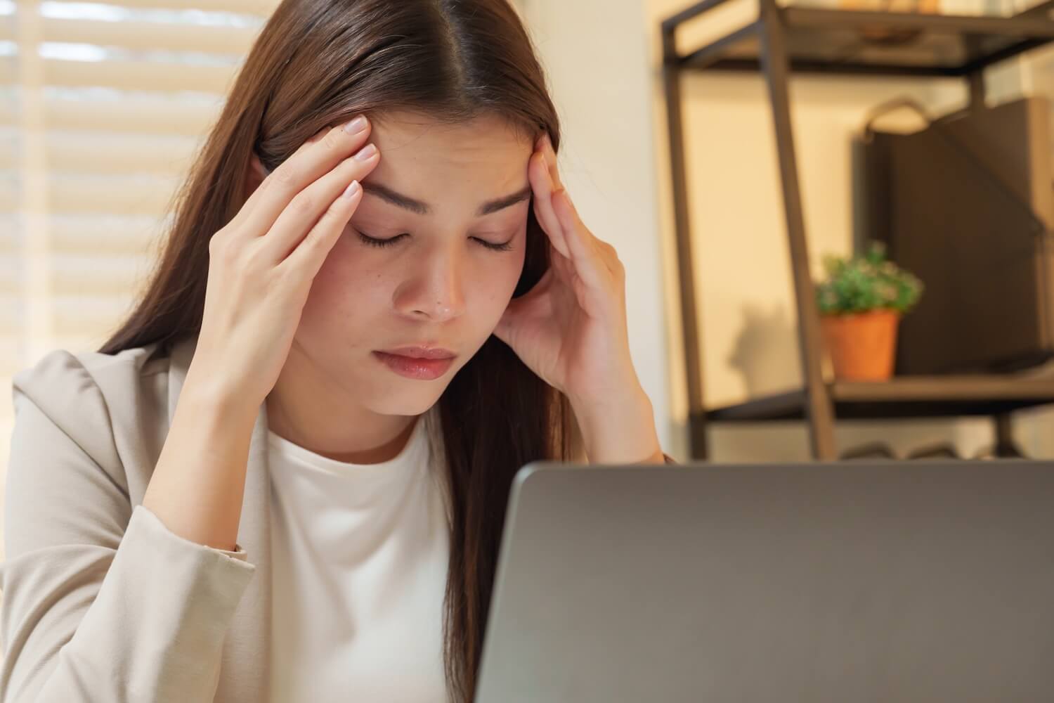Stressed employee experiencing change fatigue, highlighting the need for effective change management coaching.