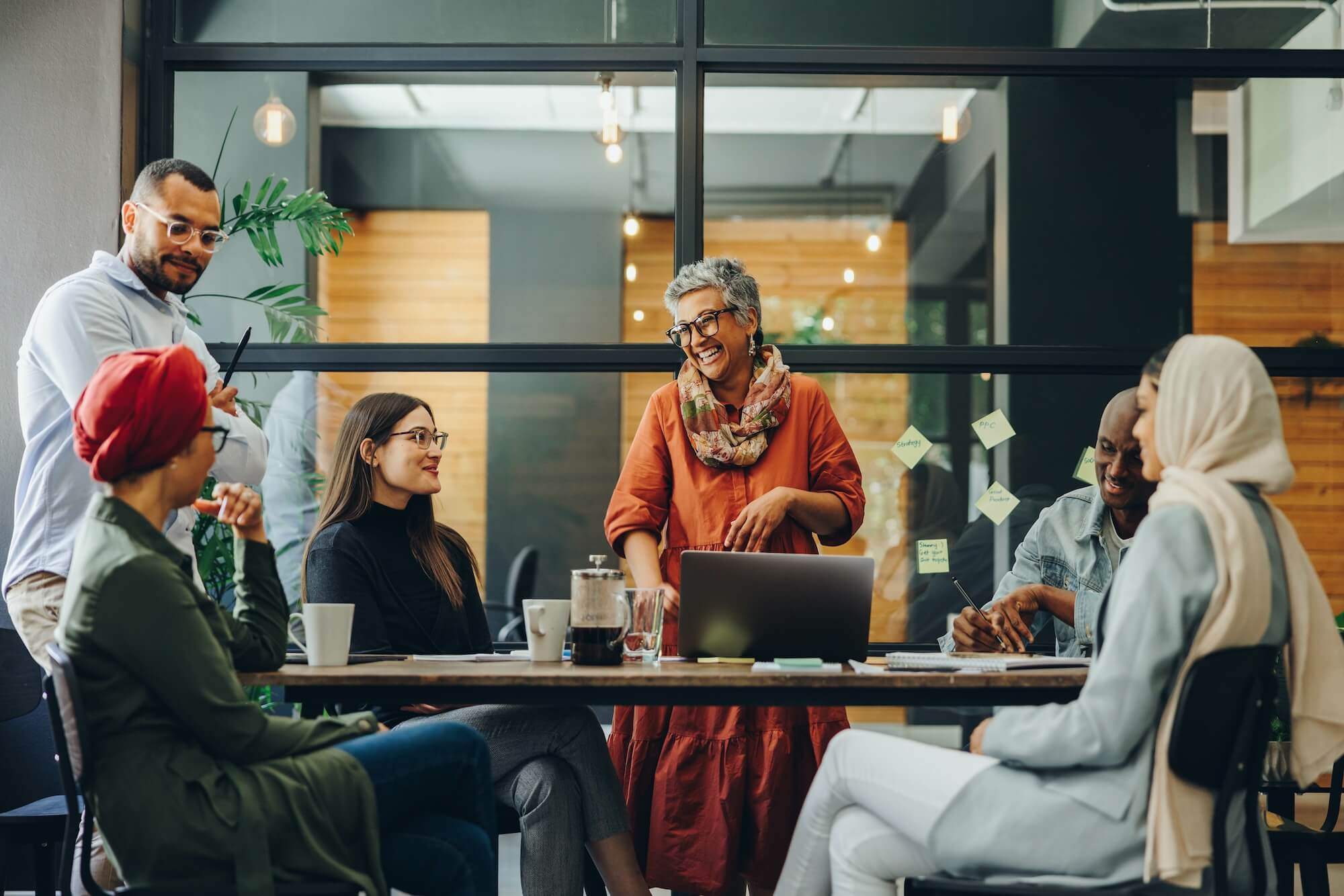 Cheerful, diverse team having a meeting in a boardroom