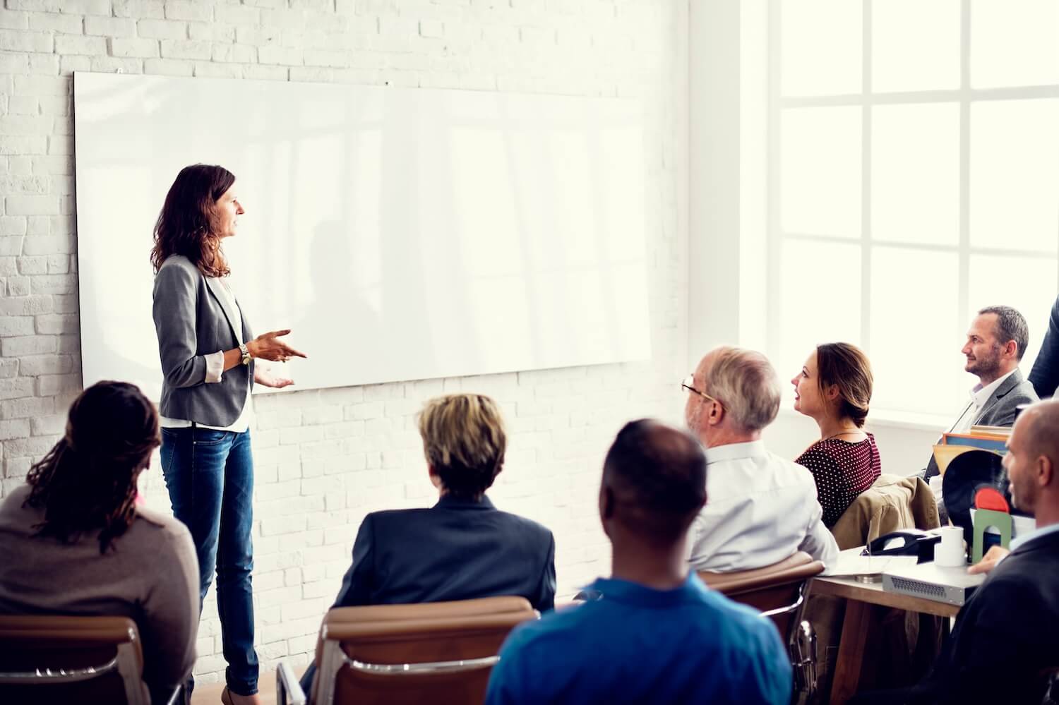 Woman talking to participants of a workshop
