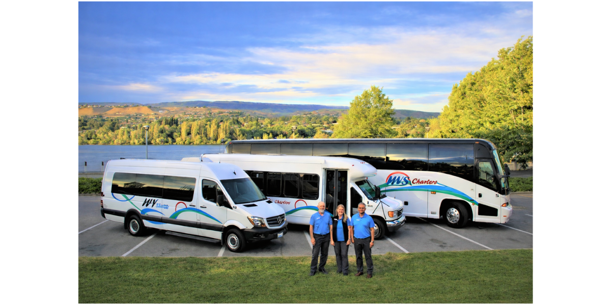 Three Wenatchee Valley Shuttle employees standing in front of a bus
