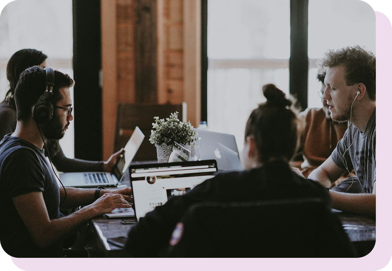 Team working at shared desk. 