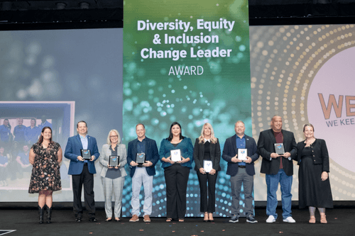 Joey Ballard, Executive Vice President of People and Safety, stands on stage accepting the 2023 ATA Diversity, Equity and Inclusion Change Leader Award