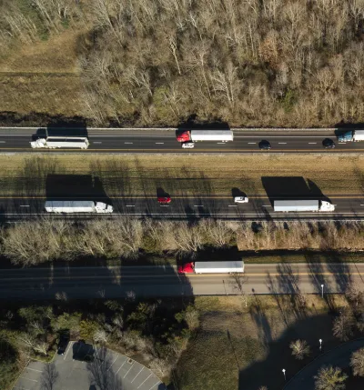 drone shot of trucks on road