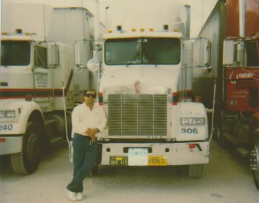 A man posing with his semi truck