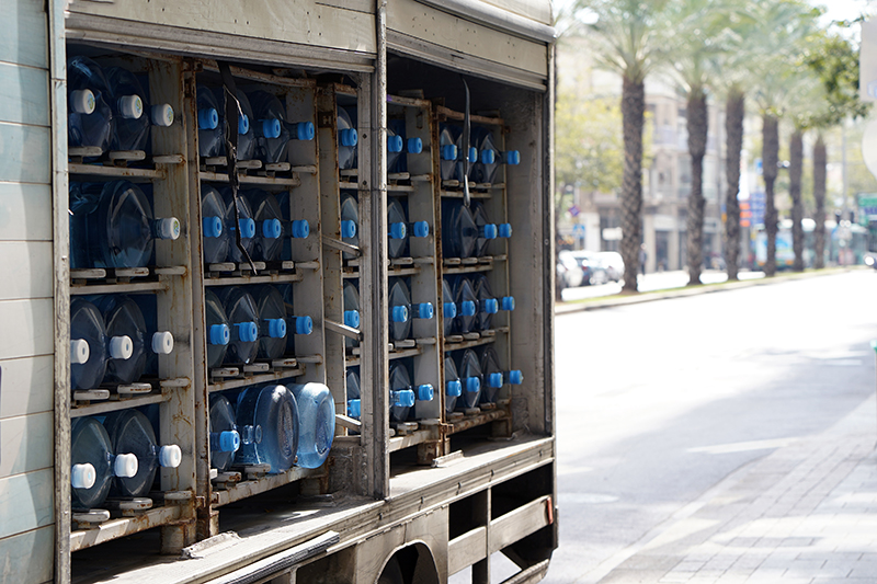 A truck full of water jugs