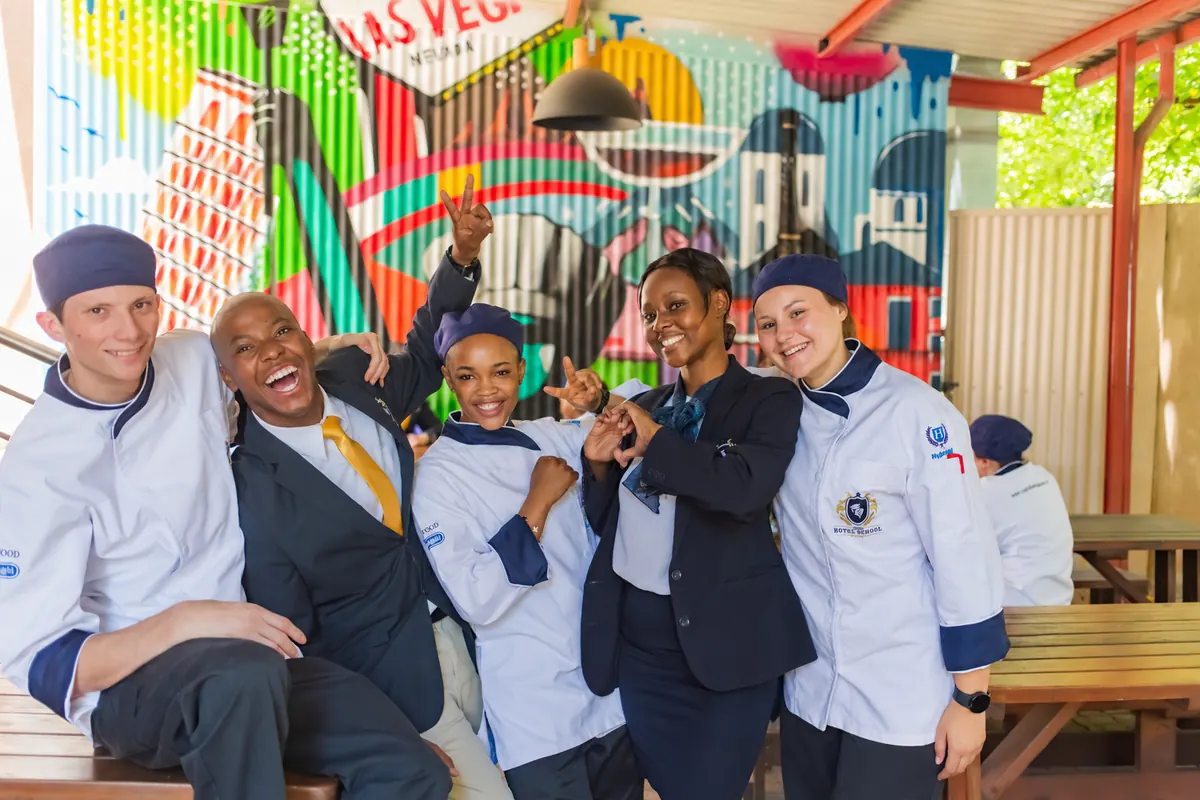 Capital Hotel School students in chef and front-of-house uniforms