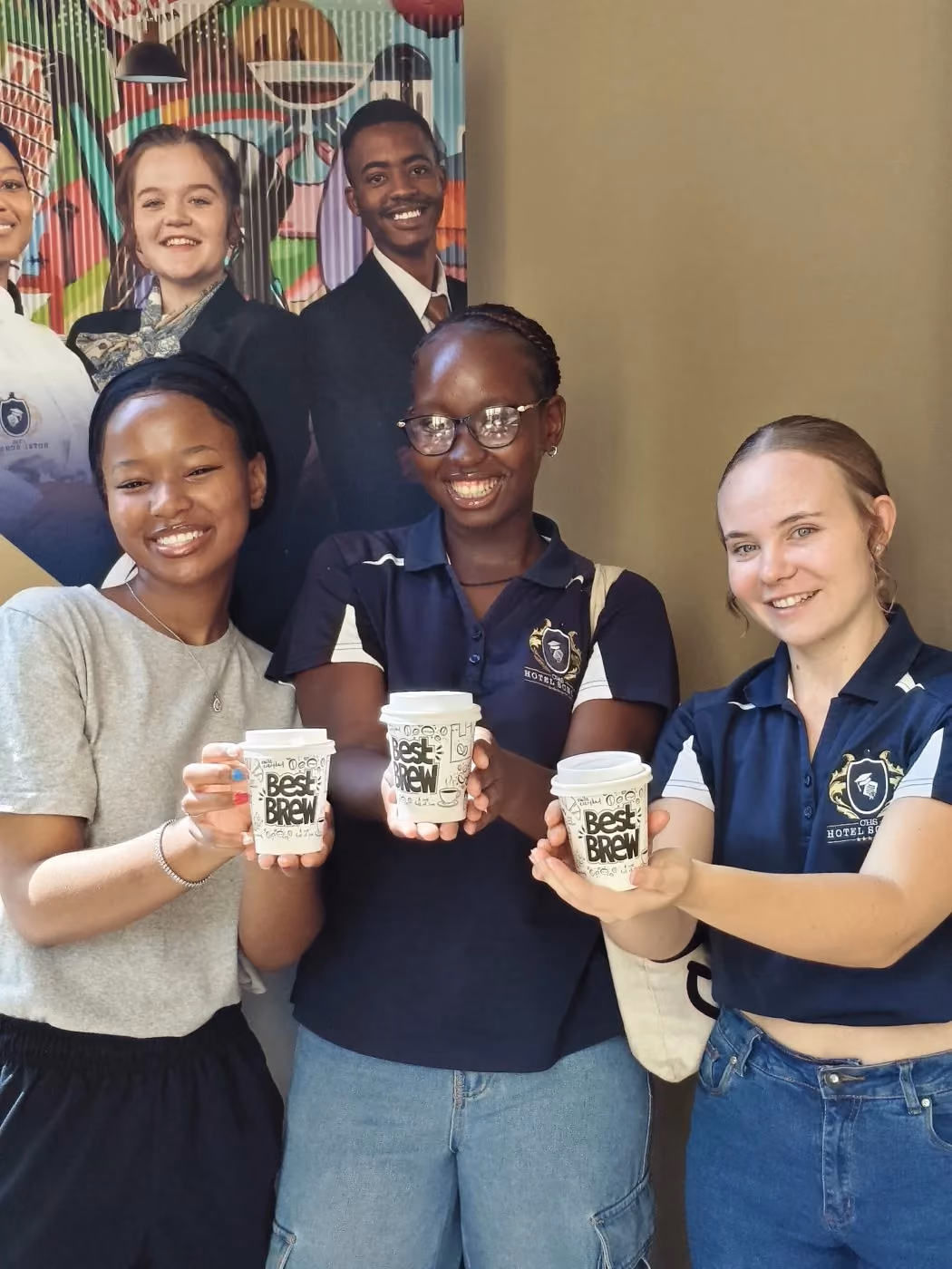 CHS students smiling and raising takeaway coffee cups
