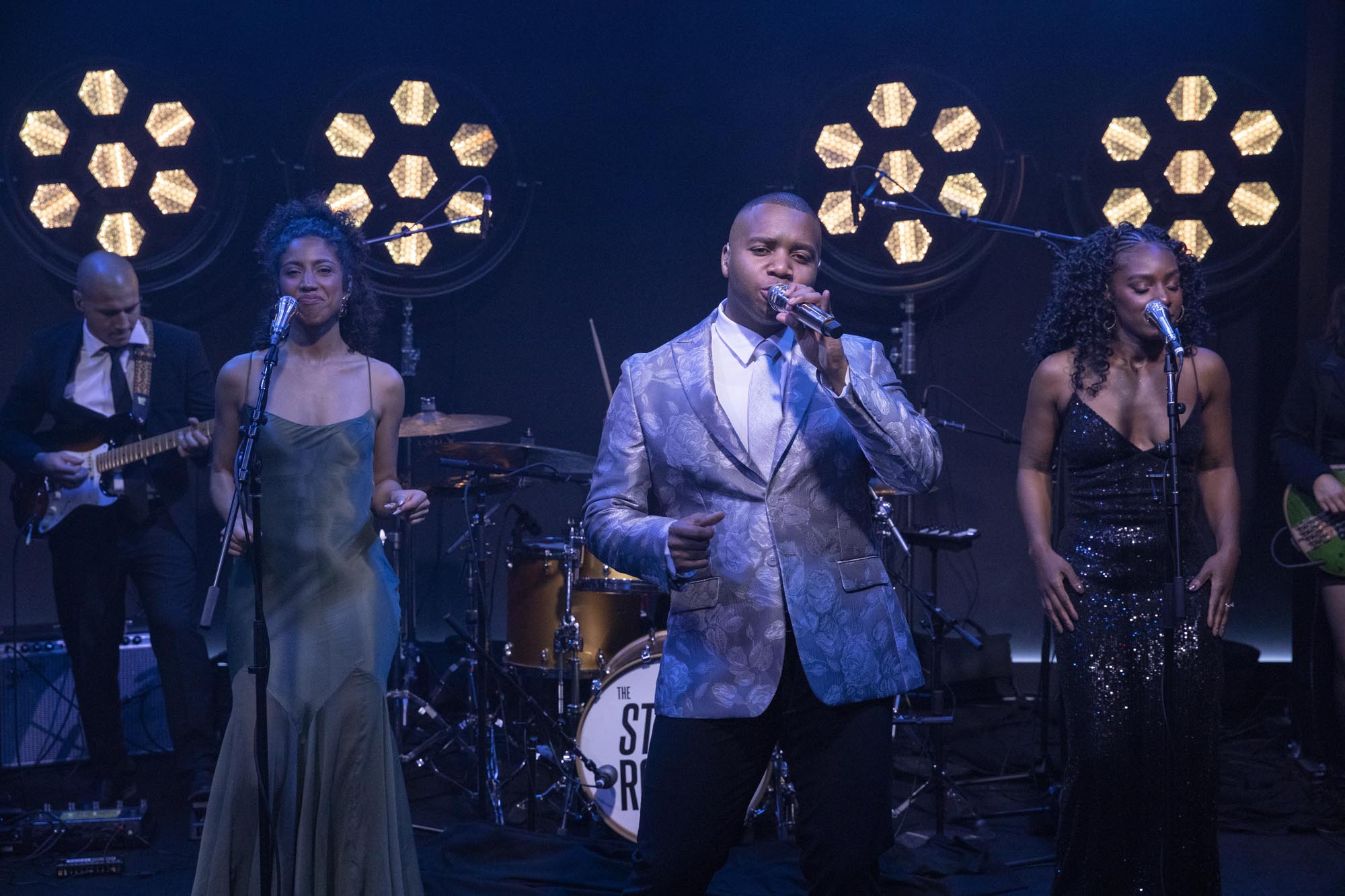 St. Royals LA party band performing live — lead vocalist and singers in formal attire on a professionally lit stage