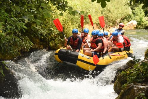 Omis croatia white water rafting, water splashing everywhere the gymsy traveller with a group of people in the raft