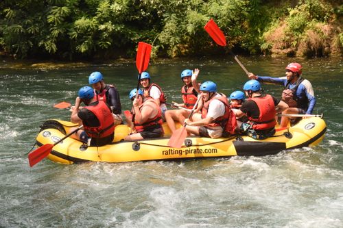 Omis croatia white water rafting calm waters oars in the air the gymsy traveller with a group of people in the raft
