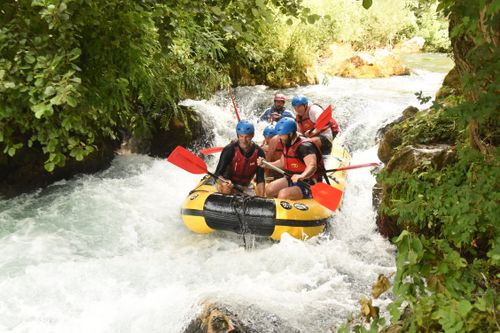 omis croatia white water rafting about to head into rough water narrow valley with trees on either side the gymsy traveller with a group of people in the raft