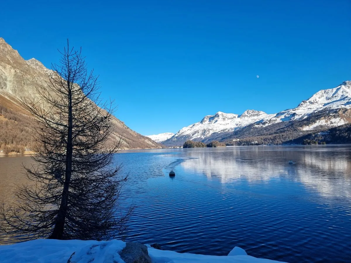 a lake in the Swiss alps along our roadtrip through europe. build up of snow on mountainsa