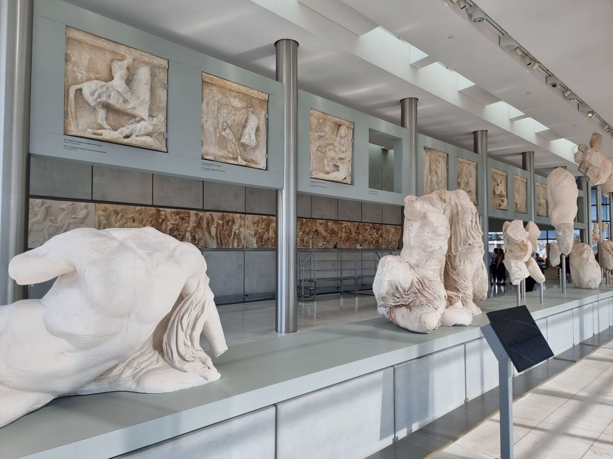 inside the museum in athens with ancient marble sculptures