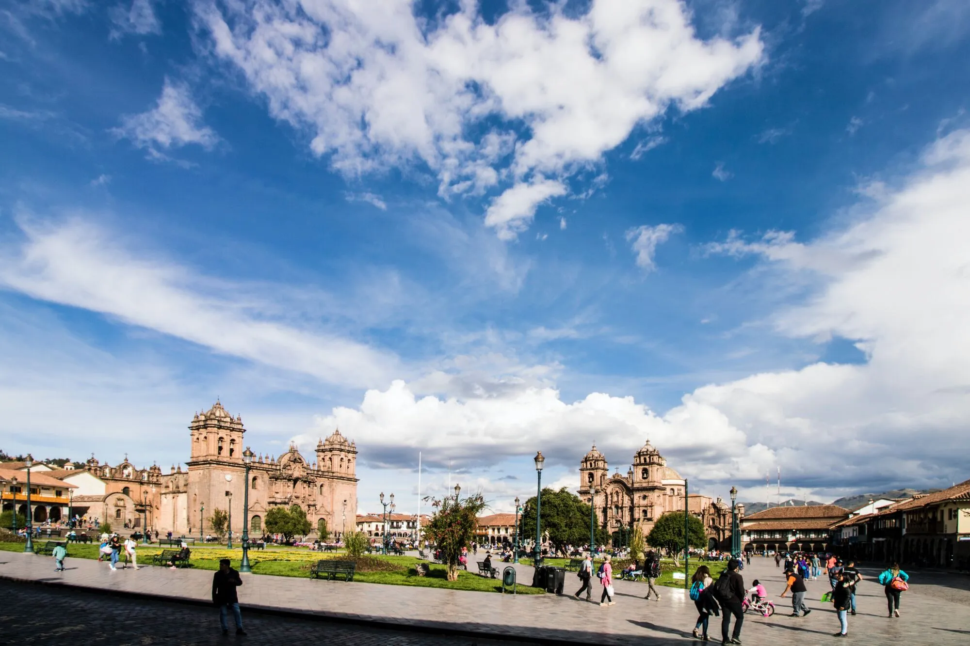 mostly clear skies overlooking a city. a Piazza or square in the city of cusco on Peru
