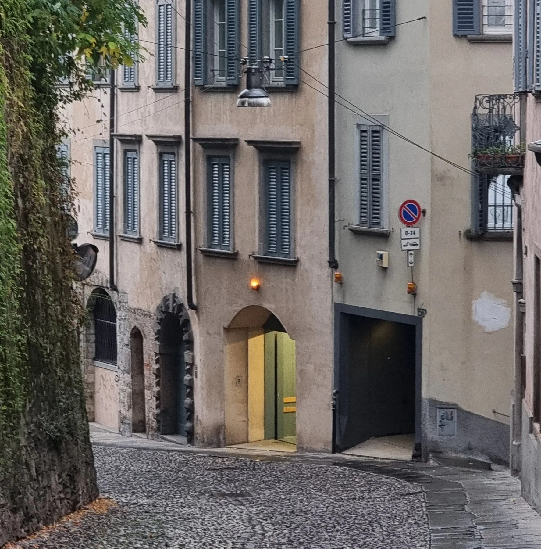 a road in bergamo with old buildings and balconies. road is pebbly. 