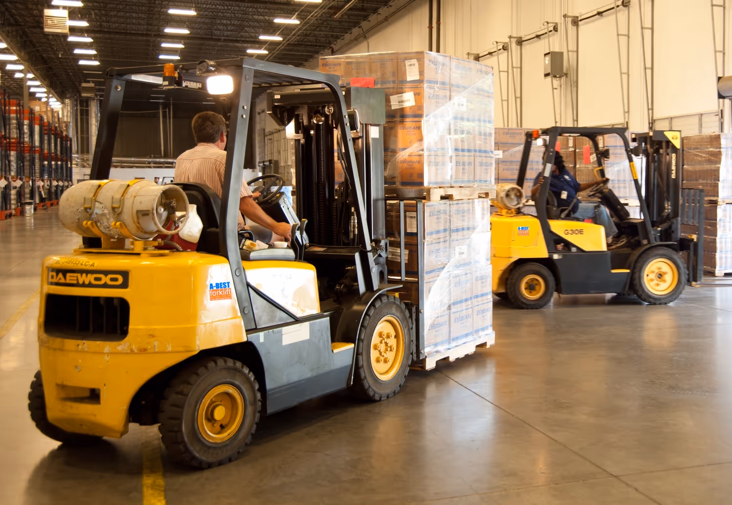 Two forklifts carrying large payloads