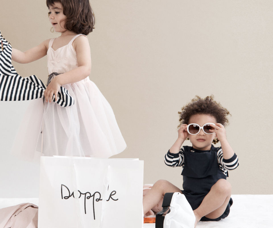 Two children try on their new clothes from Dopple.