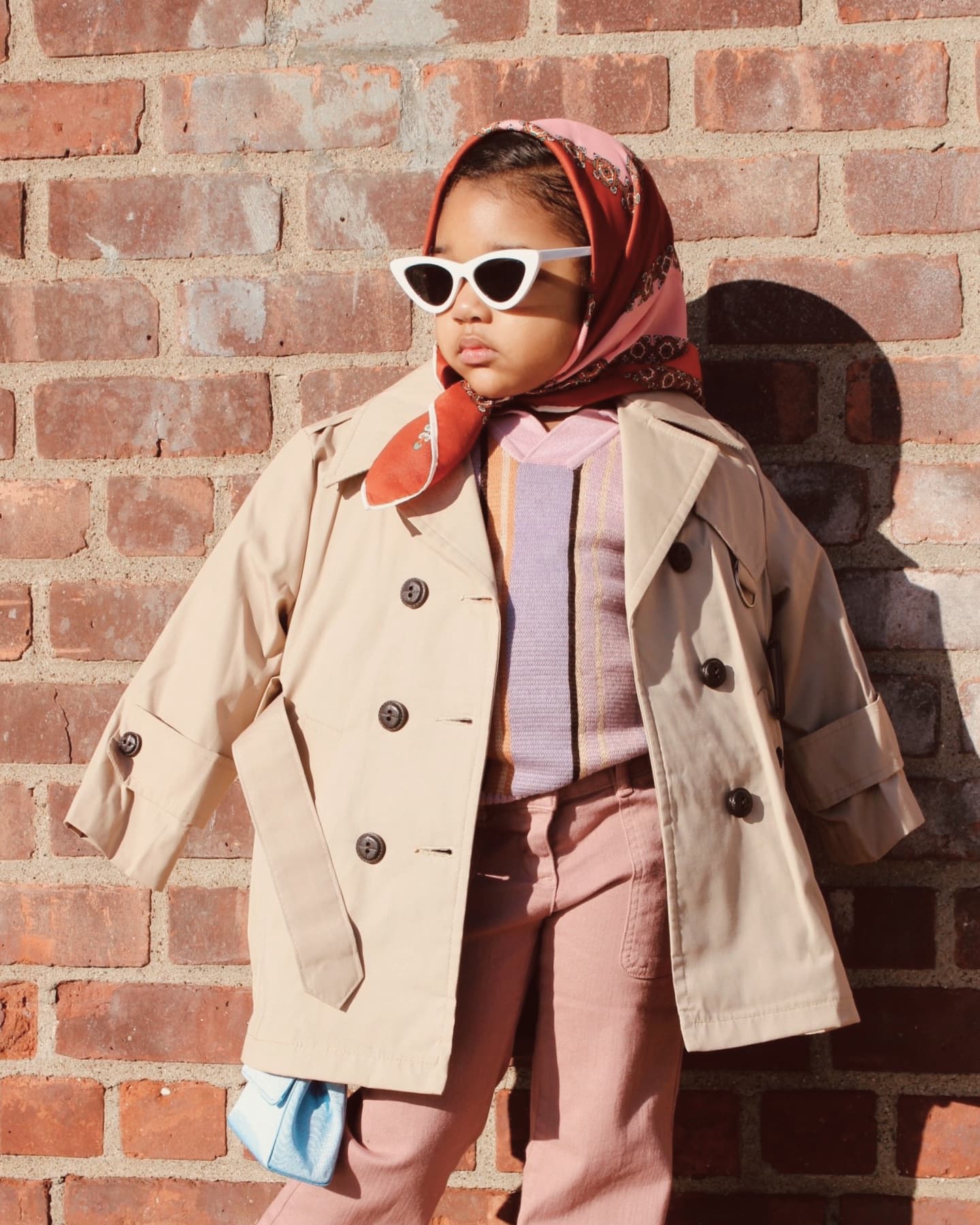 Young girl with layering and sunglasses.