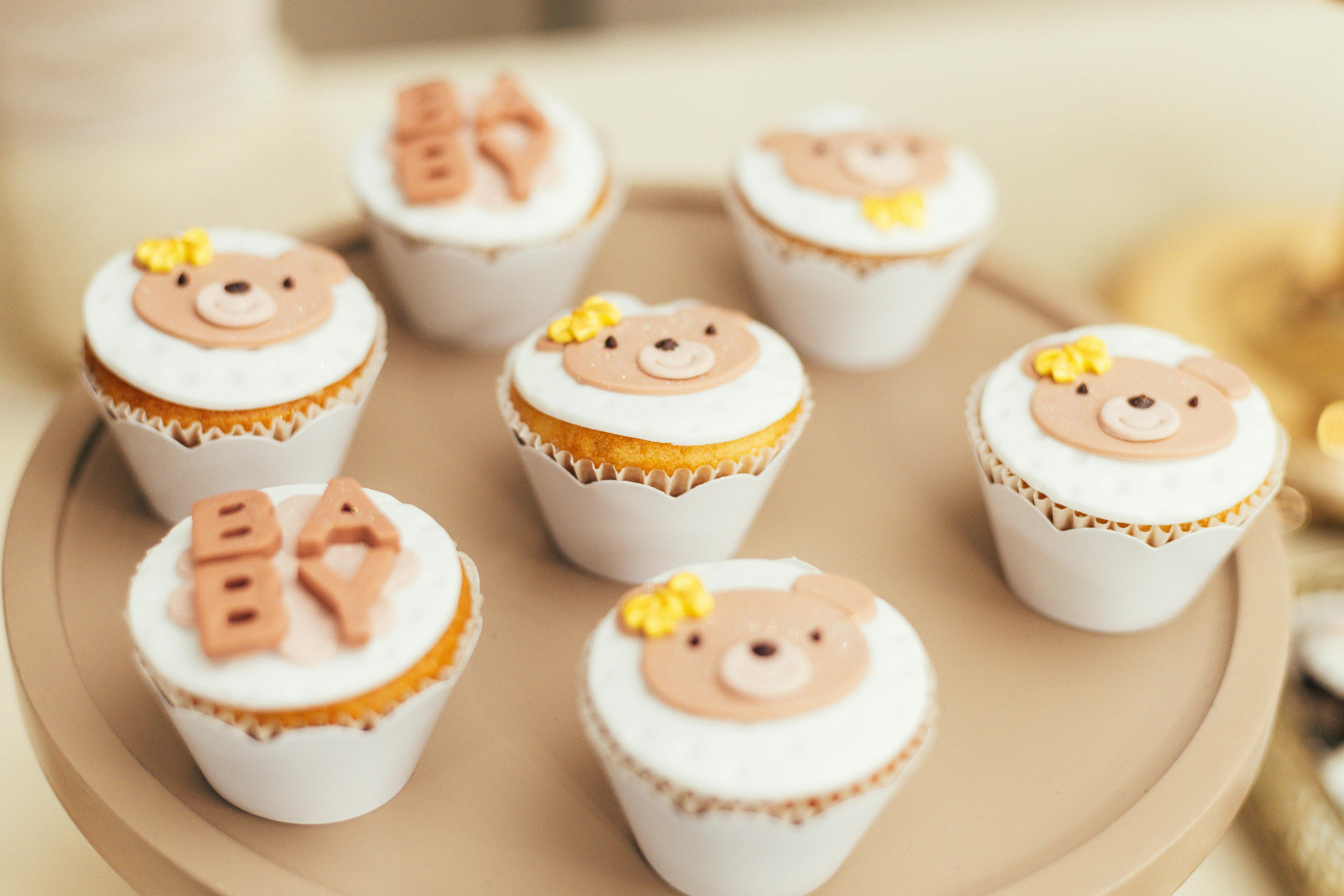 Cute cupcakes with bears and Baby on them.