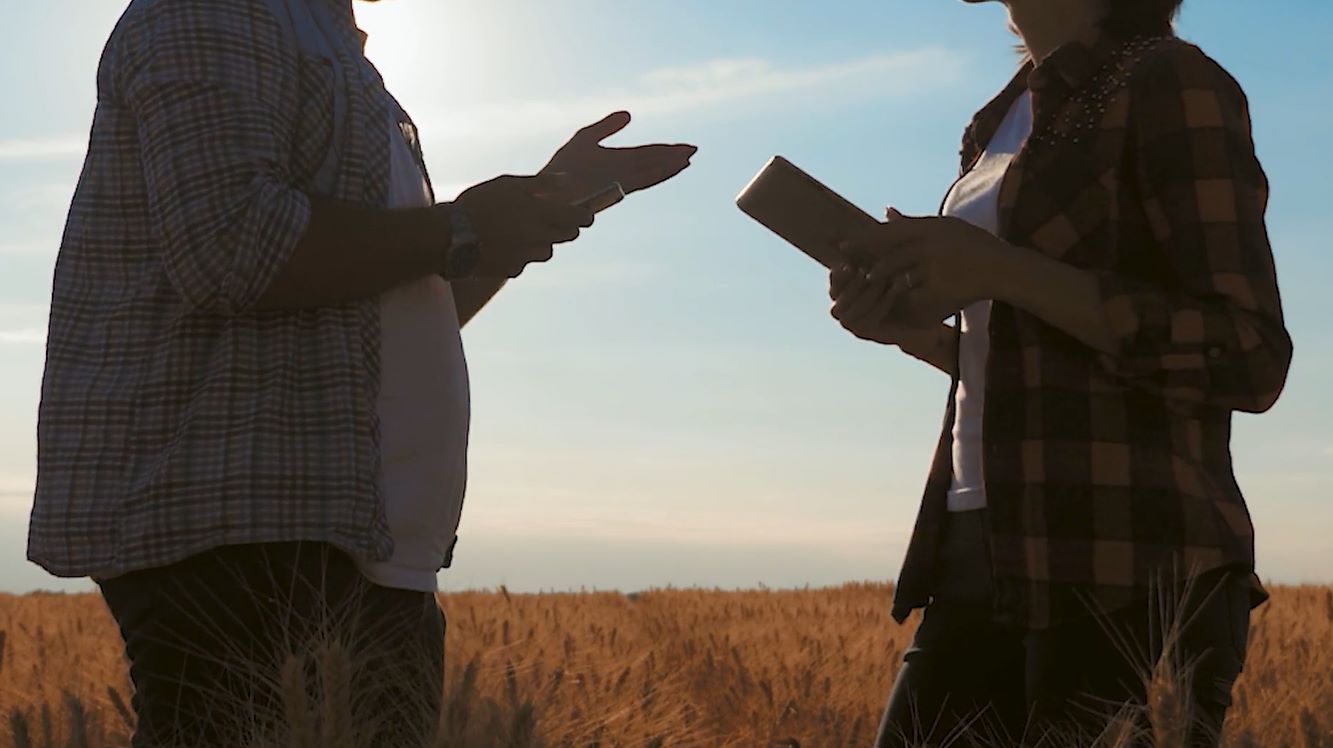 Interaction between two people holding tablet devices