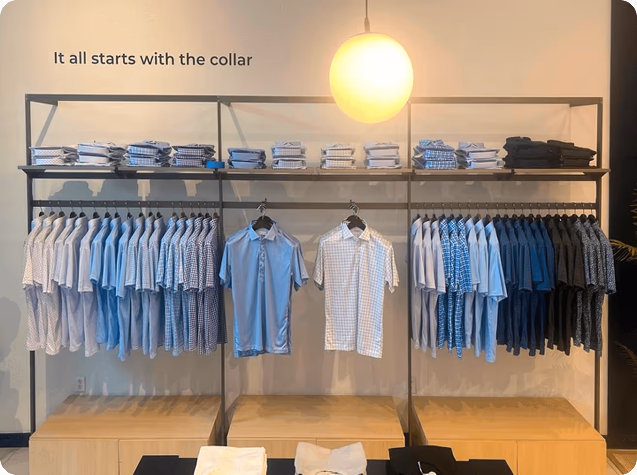 A clothing store display with shirts and shirts on racks.