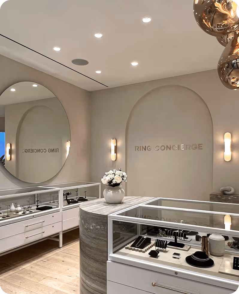 A bathroom with a large round mirror and a sink.