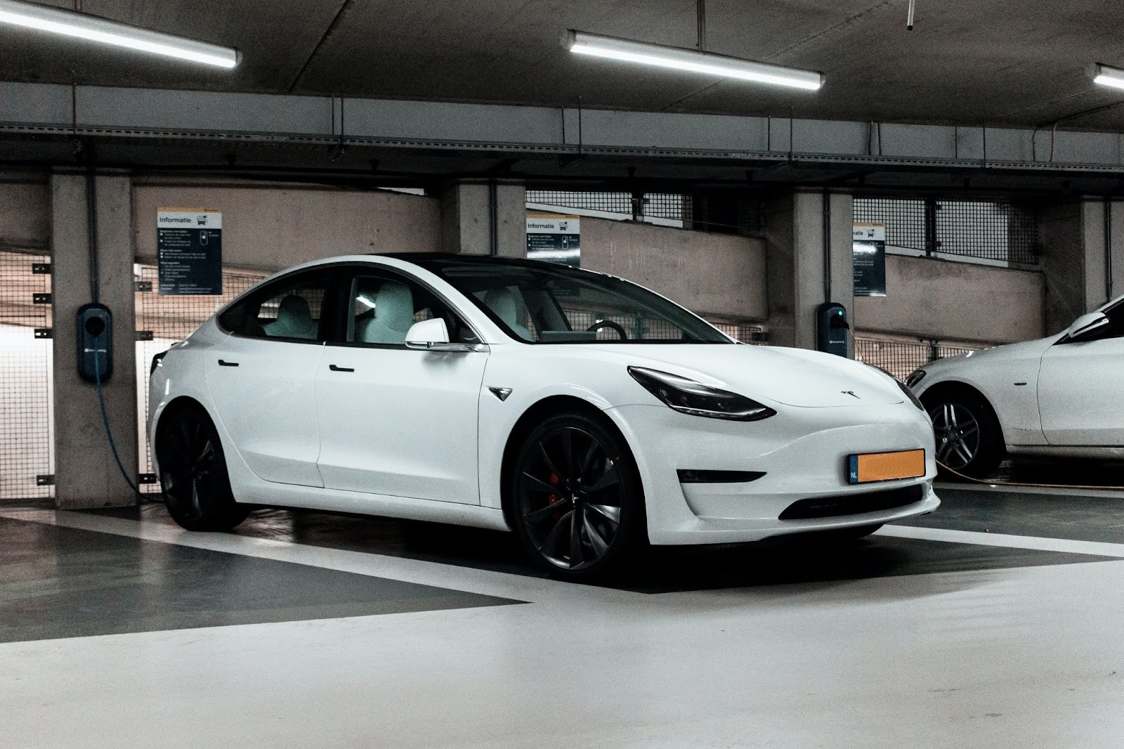 A modern electric car charging in an underground car park