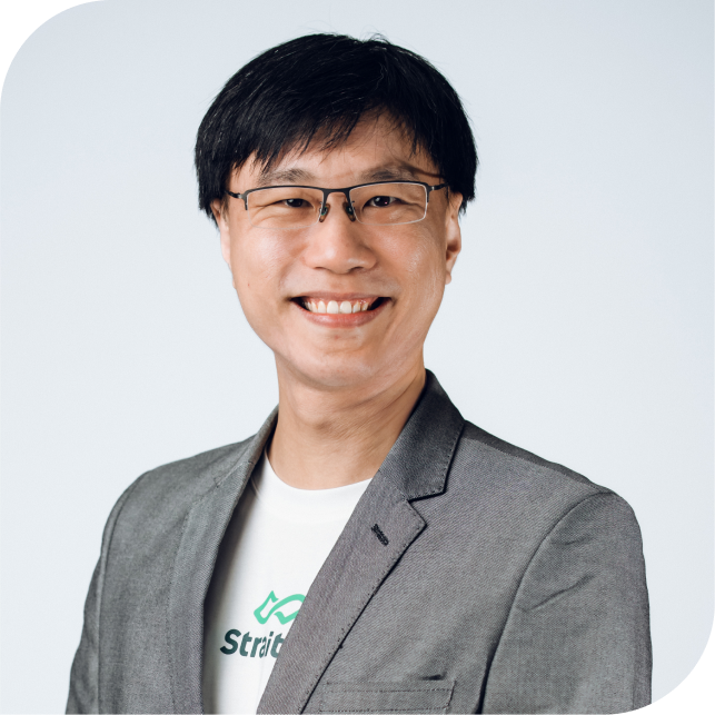 Portrait of Samson Leo, team member at StraitsX, dressed in a grey blazer against a neutral background.
