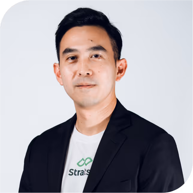Portrait of Kah Hong Tay, team member at StraitsX, dressed in a black blazer against a neutral background.