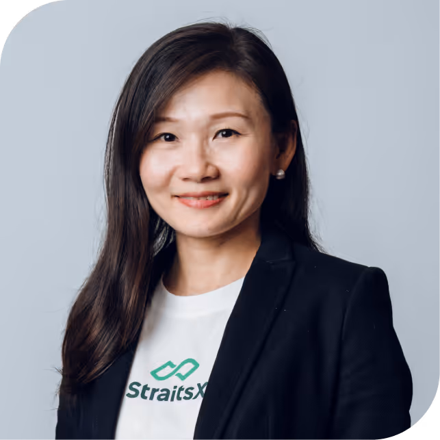 Portrait of Anthony Koo, team member at StraitsX, dressed in a black blazer against a neutral background.