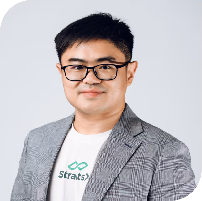 Portrait of Victor Liew, team member at StraitsX, dressed in a grey blazer against a neutral background.