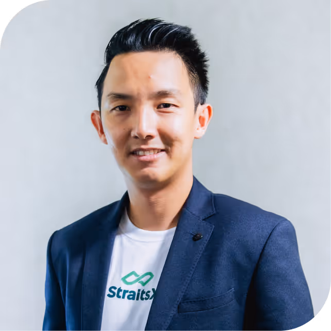 Portrait of Hendra Kwik, team member at Fazz, dressed in a navy blazer against a neutral background.