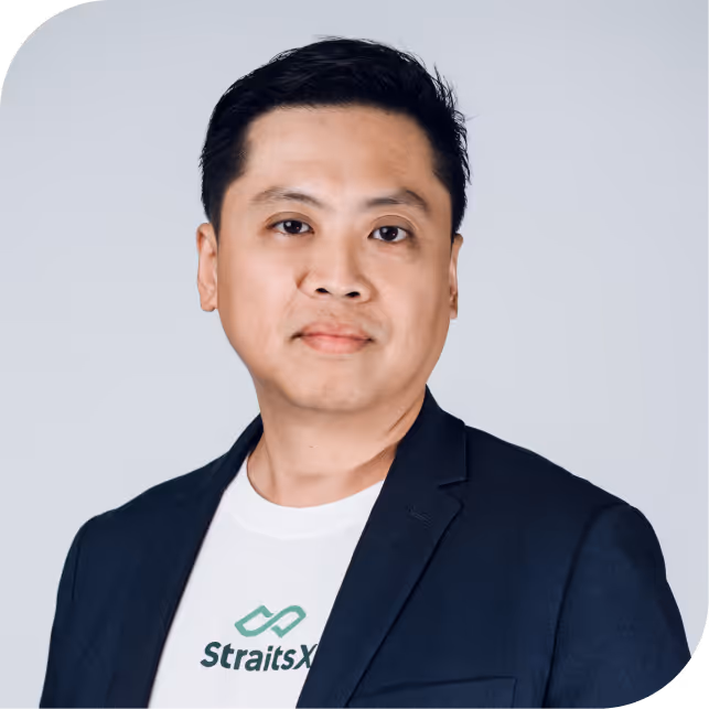 Portrait of Tianyao Liu, team member at StraitsX, dressed in a navy blazer against a neutral background.