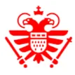 Red emblem featuring a crowned, double-headed eagle with a shield on its chest.
