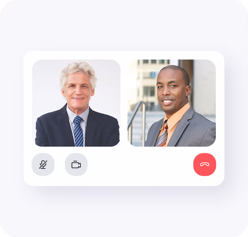 Video call screen showing a smiling older man in a suit and a younger man in a suit outdoors.