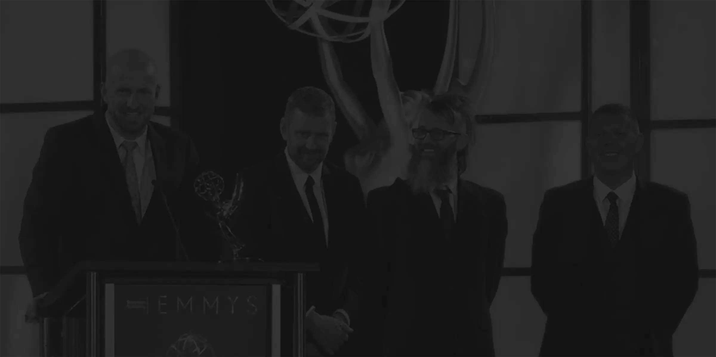 background image showing team members from Cinesync accepting award at the Academy Scientific & Technical Awards