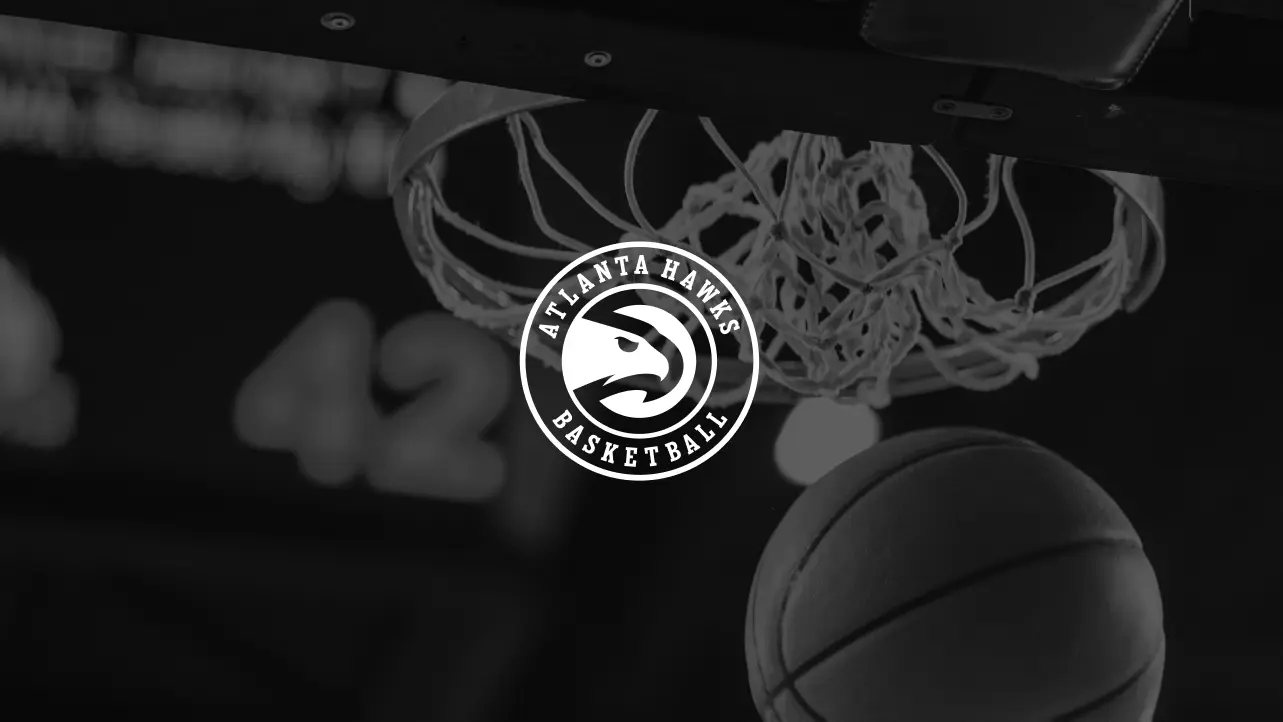 Close-up of a basketball going through a hoop with the Atlanta Hawks Basketball logo overlay.