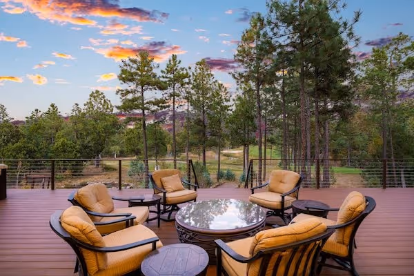 A scenic view of Show Low, Arizona, featuring forested hills, open sky, and scattered homes nestled among the trees.