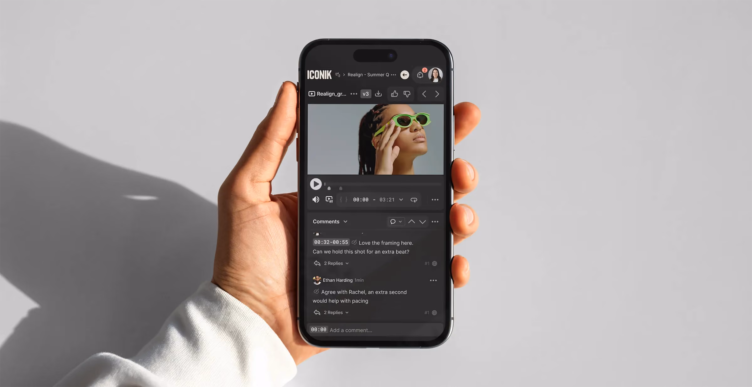 Smartphone displaying a mobile video review app featuring a video player and threaded collaboration comments.